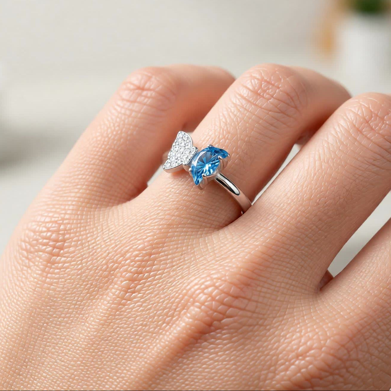 Bow Accent Ring – Sterling Silver with Blue Crystal & Pavé Details