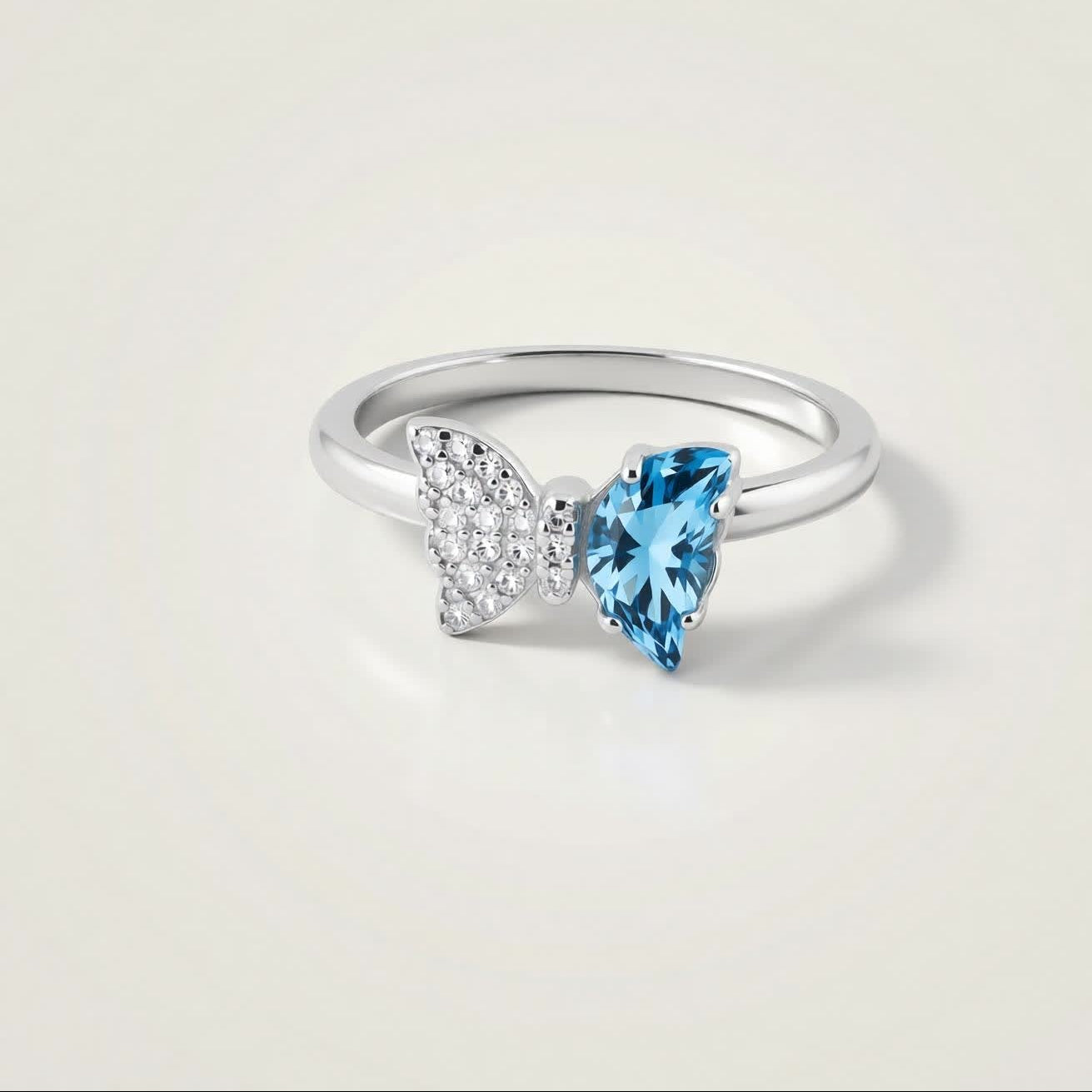 Bow Accent Ring – Sterling Silver with Blue Crystal & Pavé Details