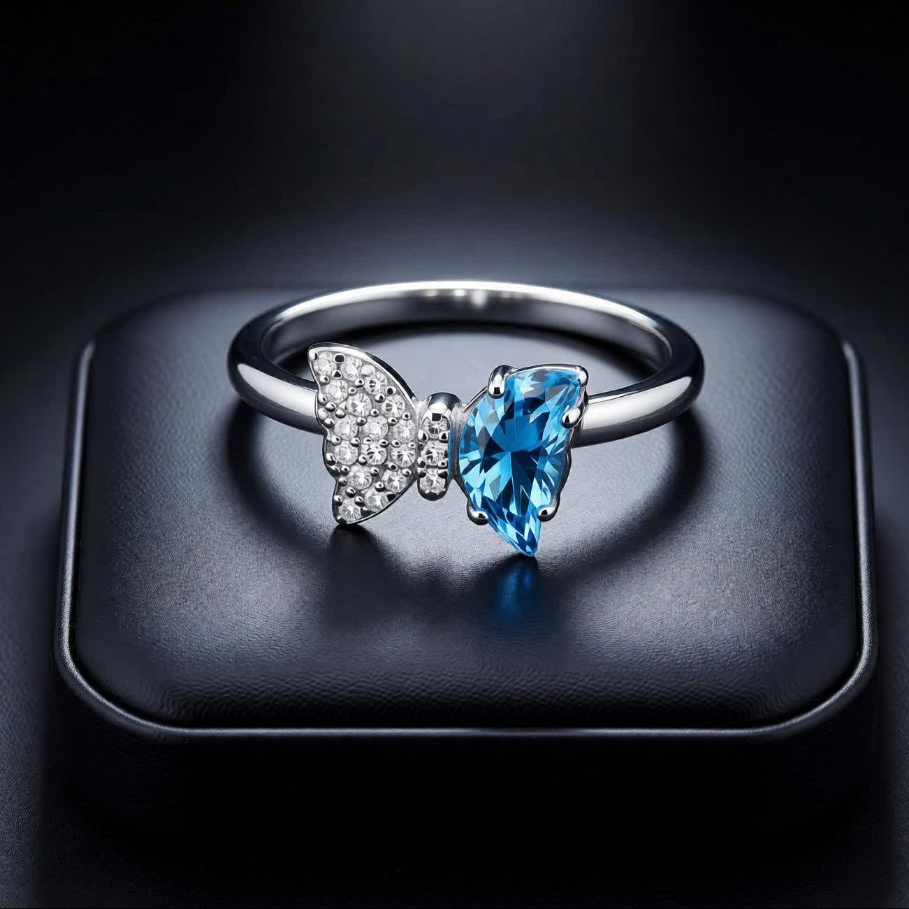 Bow Accent Ring – Sterling Silver with Blue Crystal & Pavé Details