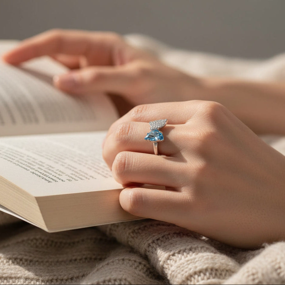 Bow Accent Ring – Sterling Silver with Blue Crystal & Pavé Details